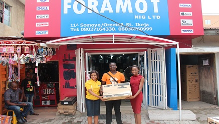 Winner Of Kaymu Easter Bunny Hunt, Feyisan Ayo-Vaughan (m) receiving his prize while Tomiwa Oladele,